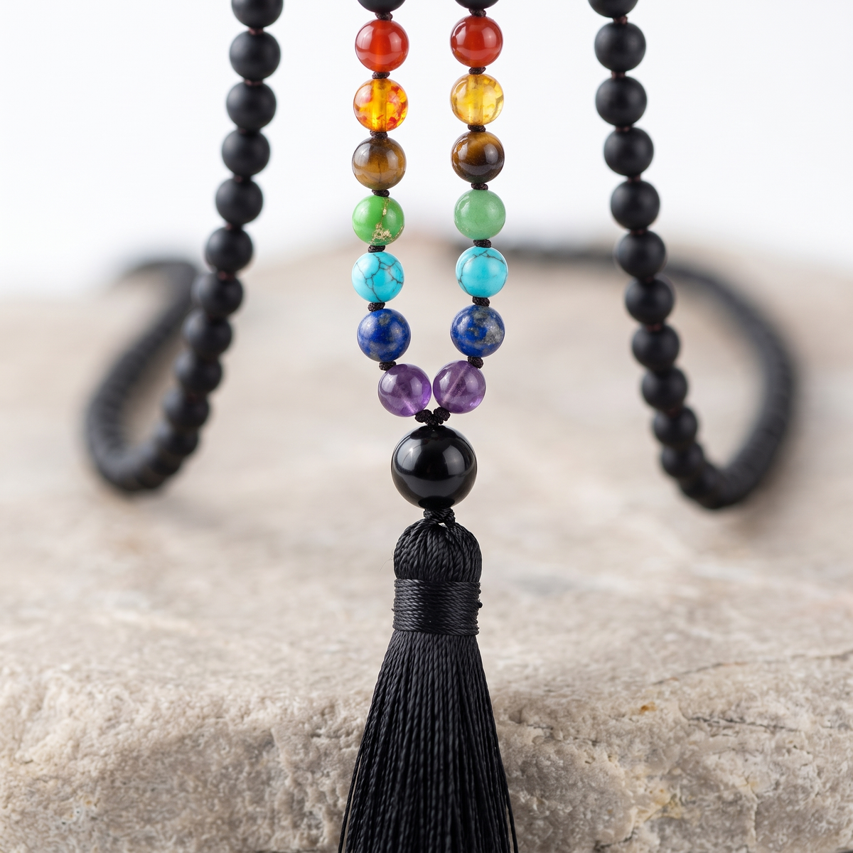 Close up of the seven chakra stones on the Matte Black mala