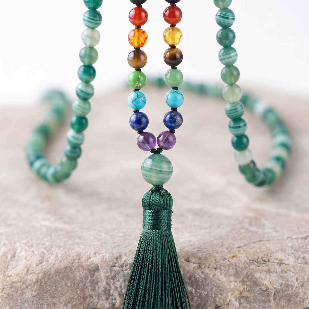 Close up of the seven chakra stones on the Sea Green Agate mala