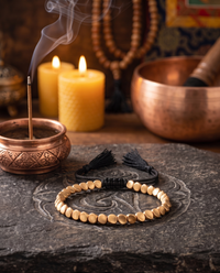 Tibetan Copper Shield Bracelet on an altar with incense and candles - Black