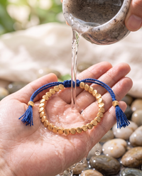 Cleansing the Tibetan Copper Shield Bracelet with water - Blue
