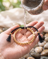 Cleansing the Tibetan Copper Shield Bracelet with water - Black