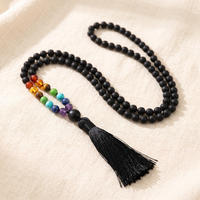 Matte Black 7 Chakra Mala Necklace on cream linen