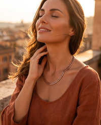 Woman wearing the Copper Shield Magnetic Necklace at golden hour