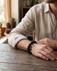 Man wearing the Buddha Mala Bracelet at a table